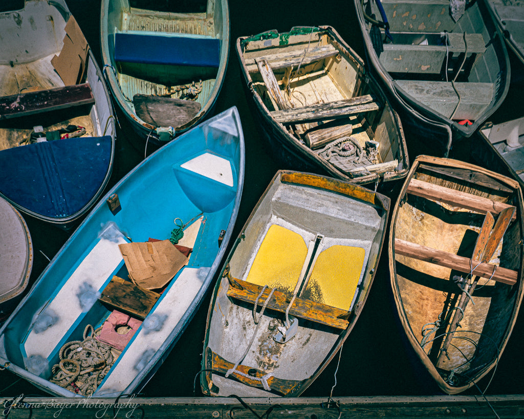 little rowboats clustered together at dock