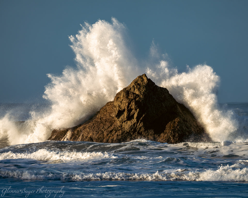 large wave crashing into rock in the ocean