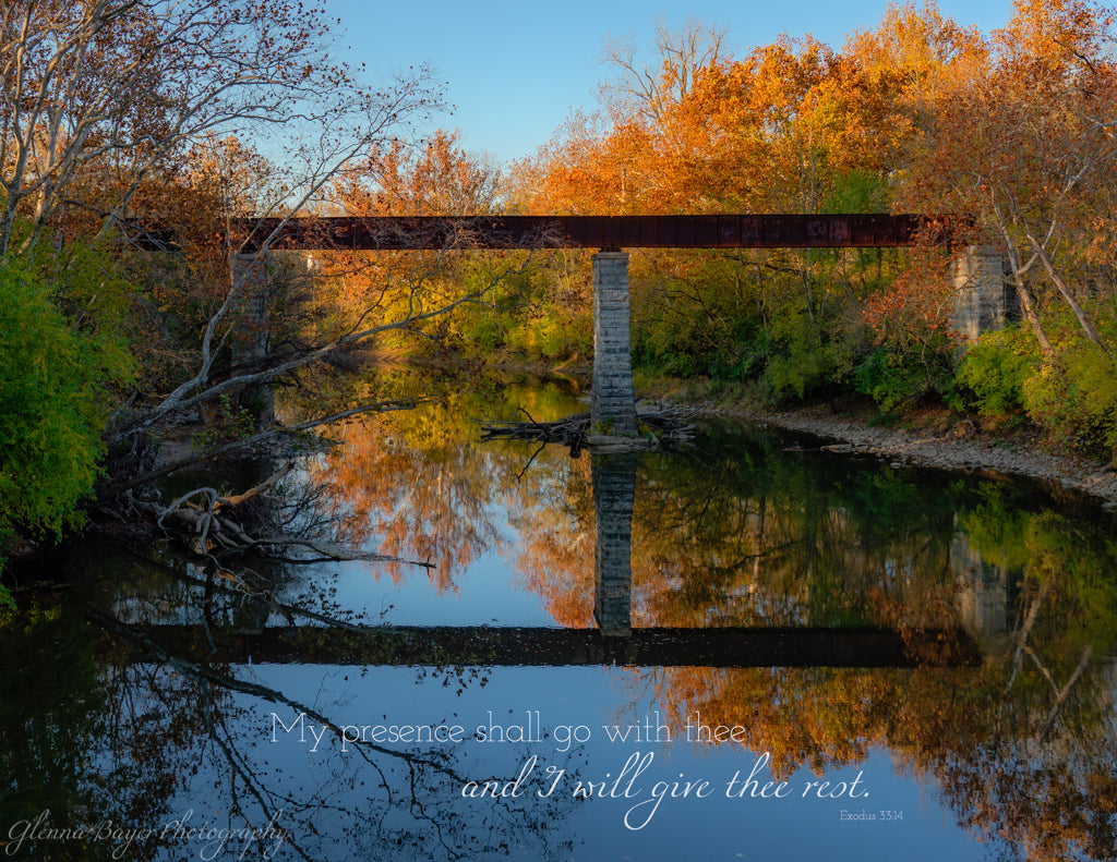 Bridge over Stillwater river in evening with bible verse