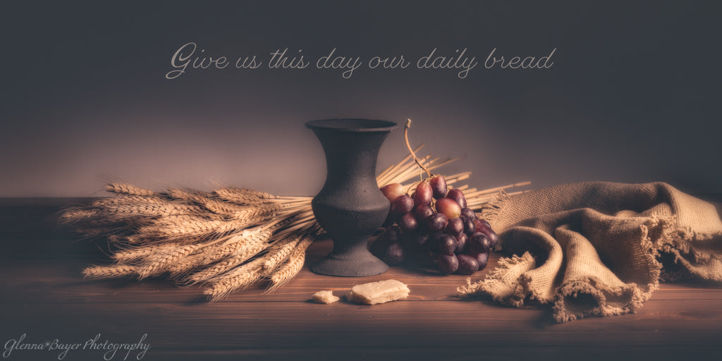 Communion bread still life with grapes and wheats