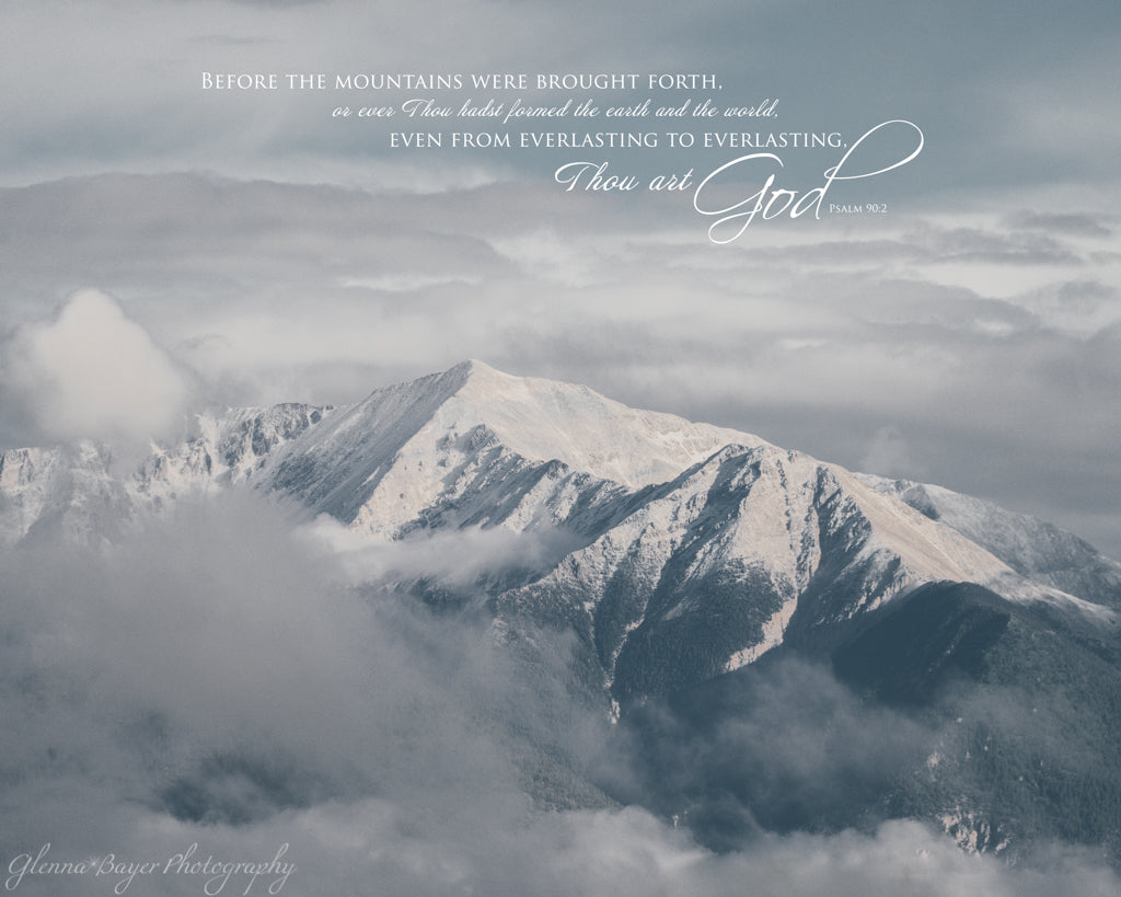 Snow capped mountains above clouds with bible verse