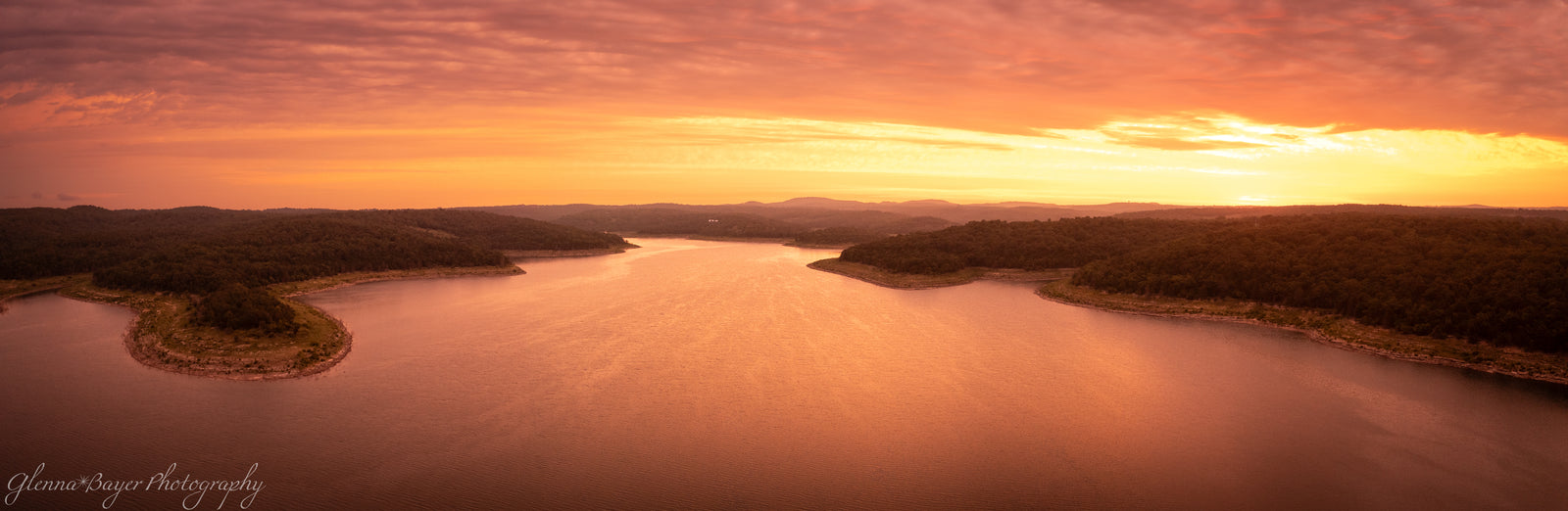 dramatic orange sunrise over lake