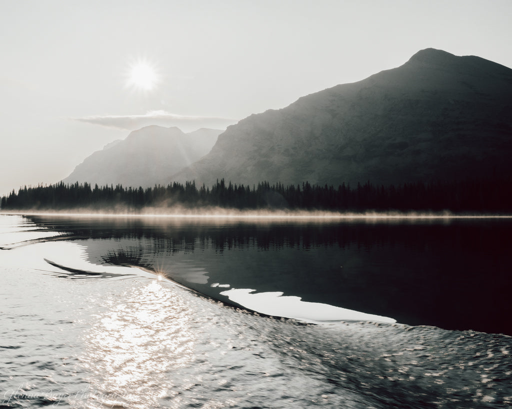 lake with fog and mountains in background
