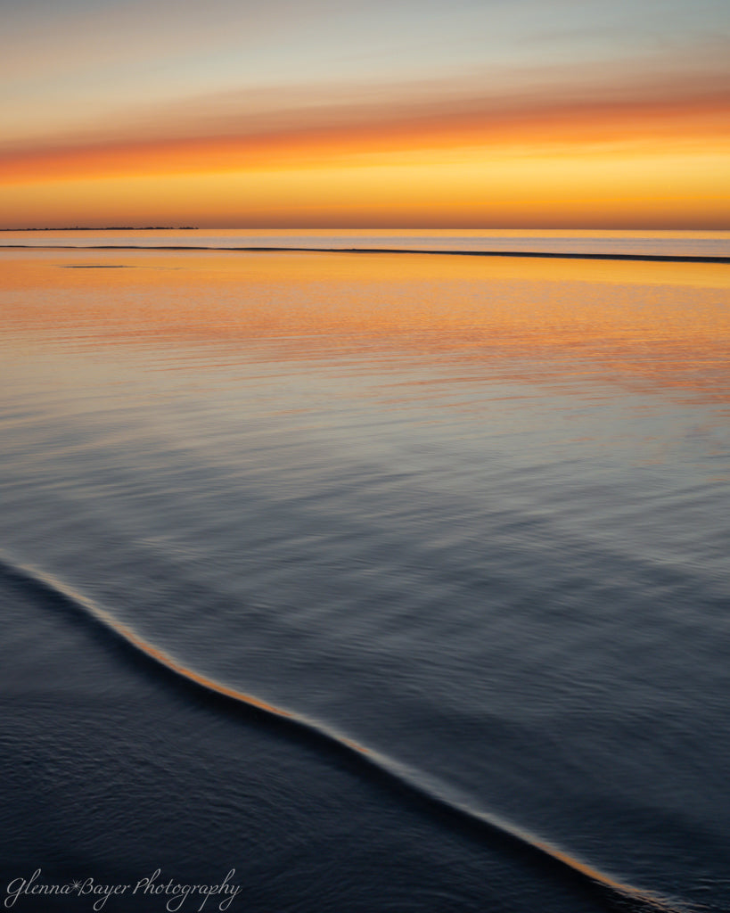 small ripple in lake at sunset