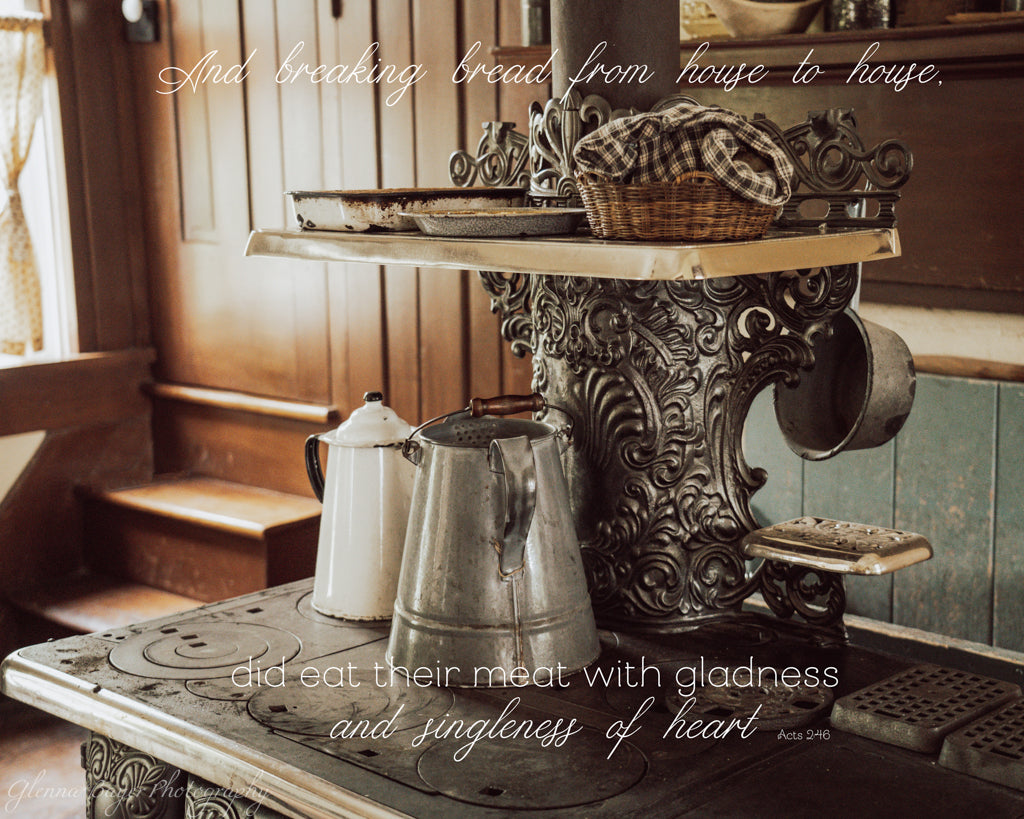 Vintage kitchen scene with a wood burning kitchen stove and vintage water pitchers.  