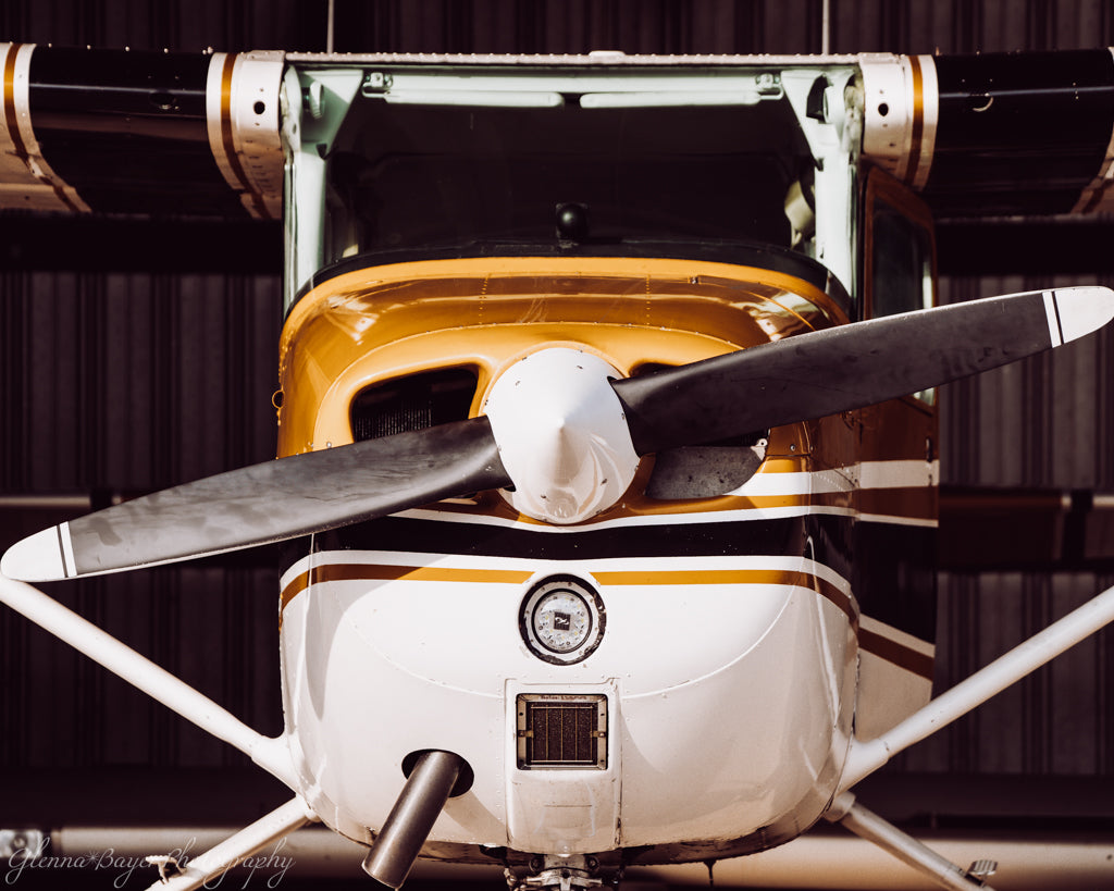 Close-up of a small airplane with a propeller against a dark background