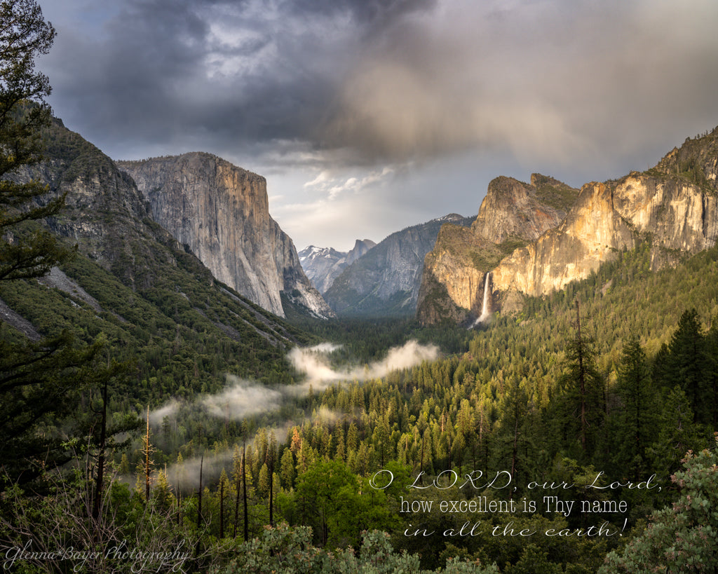 Scenic view of a mountain valley with a waterfall and clouds with a Bible verse