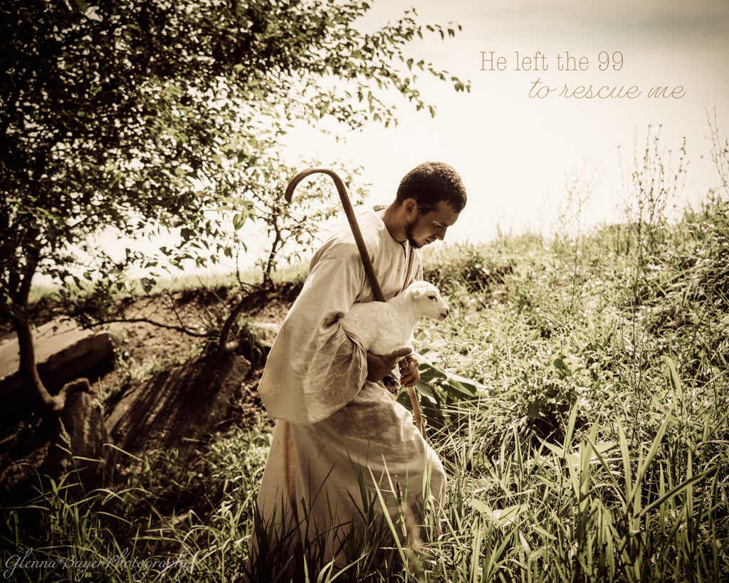 Man walking holding a lamb and staff