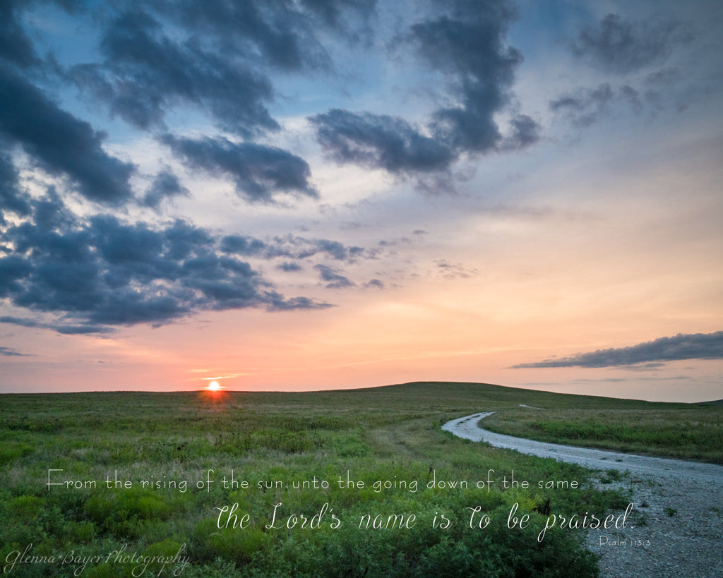 Gravel road through the grassy landscape of the Flint Hills in Kansas during sunset with scripture verse