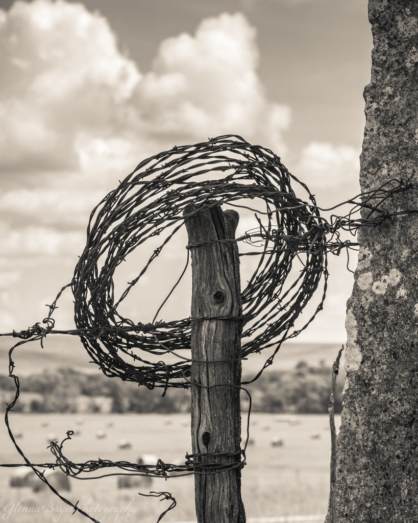 Barbed wire wrapped around post in Flint Hills, Kansas