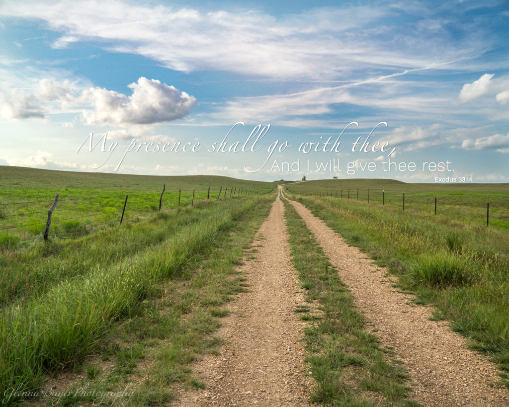 Gravel road through grassy landscape in Kansas with scripture verse