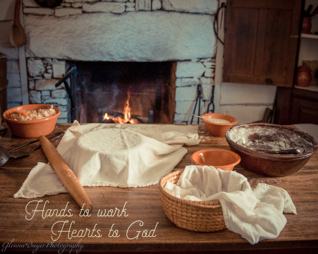 Old time baking with fireplace with quote "Hands to work, Hearts to God"