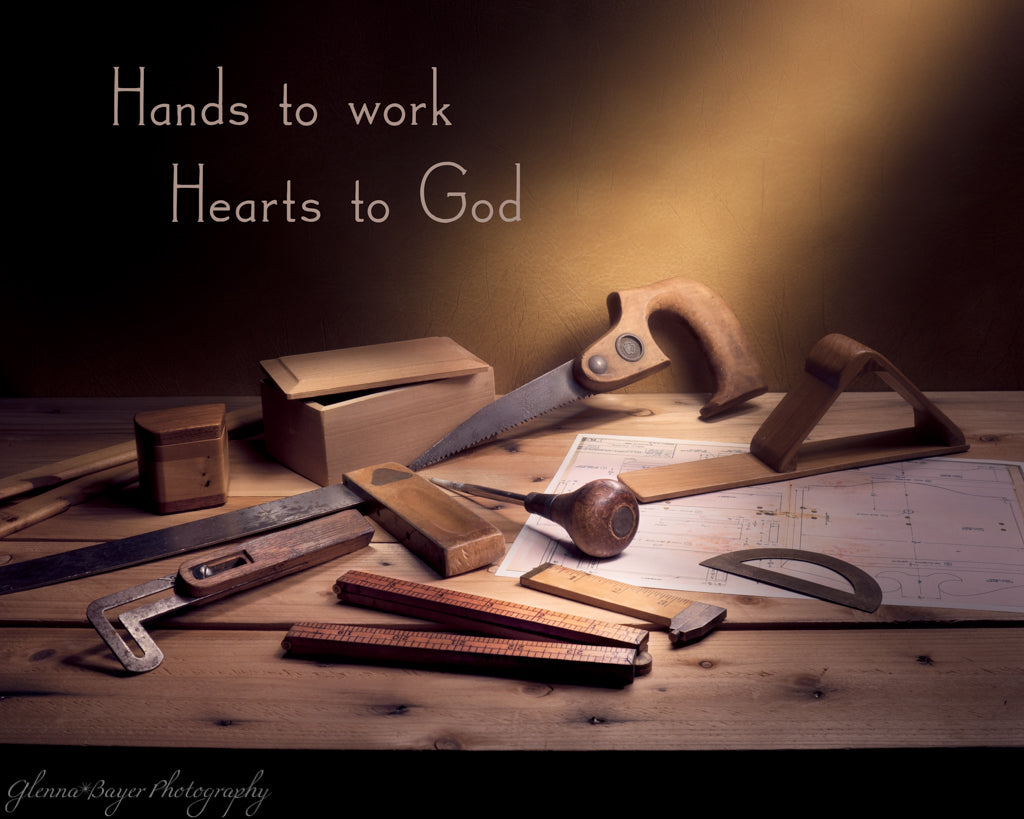 Old woodworking tools still life with quote "Hands to work, Hearts to God"