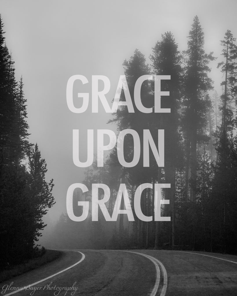 A bend in the road through foggy trees in black in white with words &quot;Grace Upon Grace&quot;