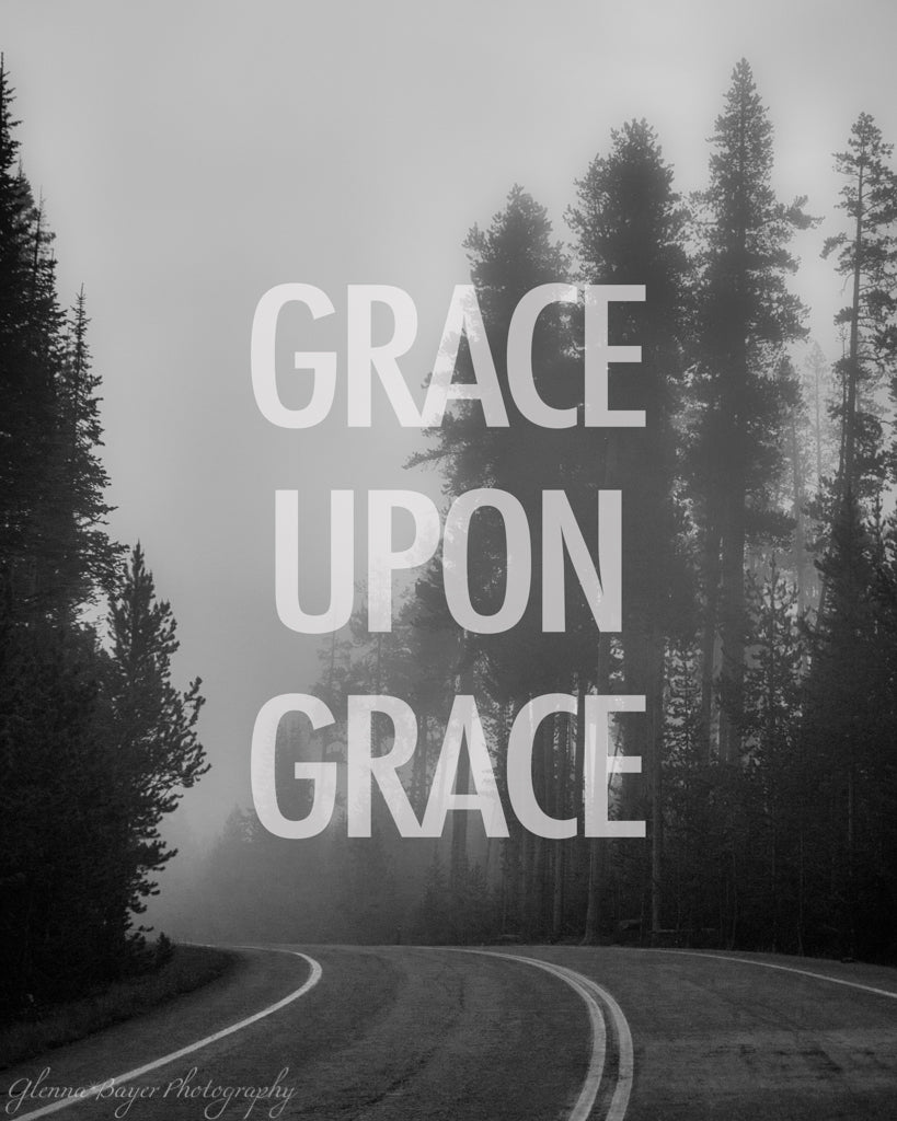 A bend in the road through foggy trees in black in white with words "Grace Upon Grace"