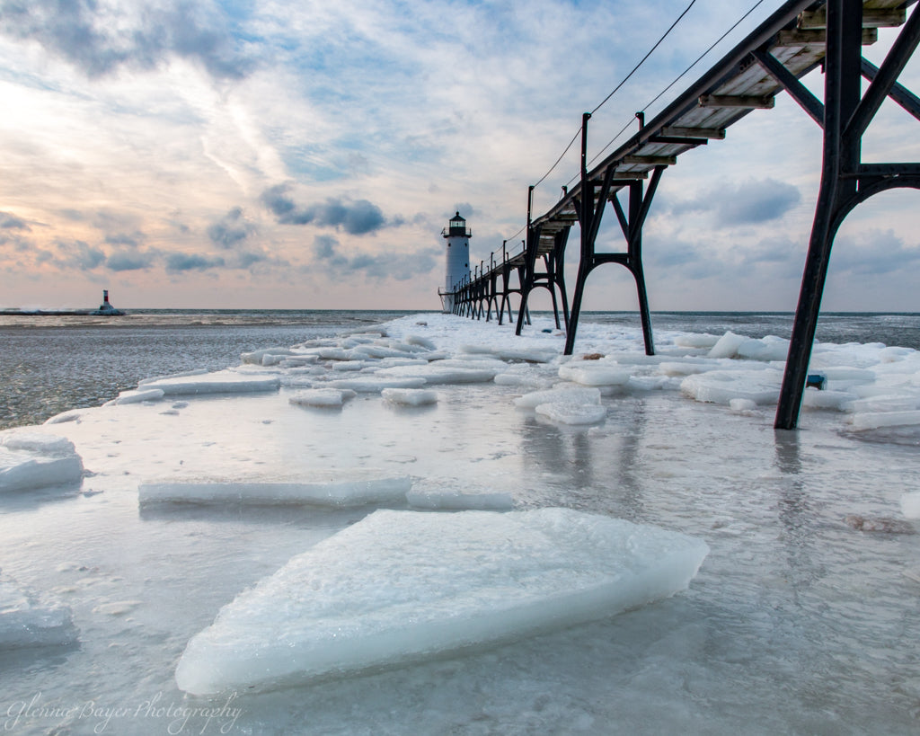 Manistee Lighthouse on Lake Michigan during winter with ice chunks