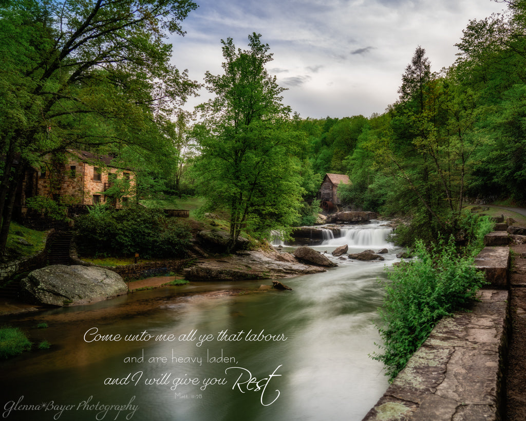 Babcock mill next to flowing river in summer with bible verse