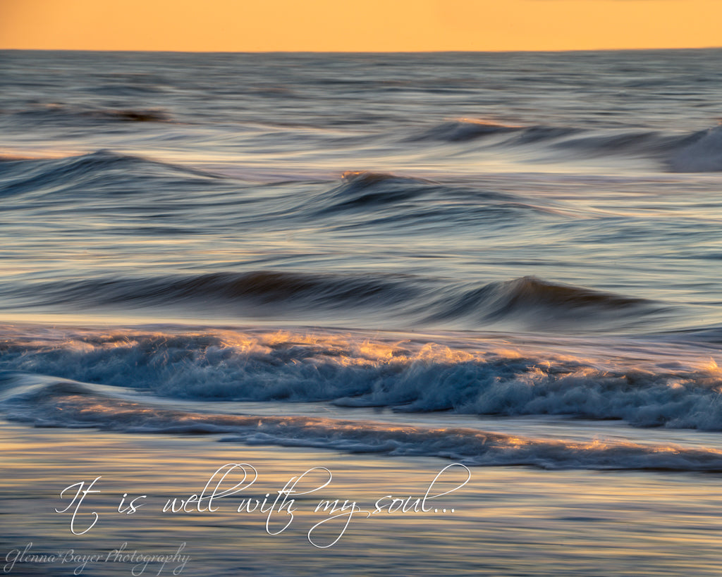 ocean waves at sunset with quote "it is well with my soul"