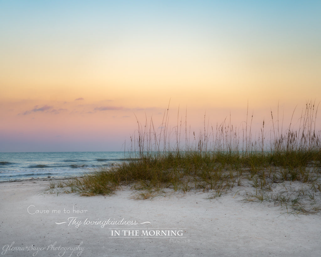 Pastel sunrise on beach with bible verse