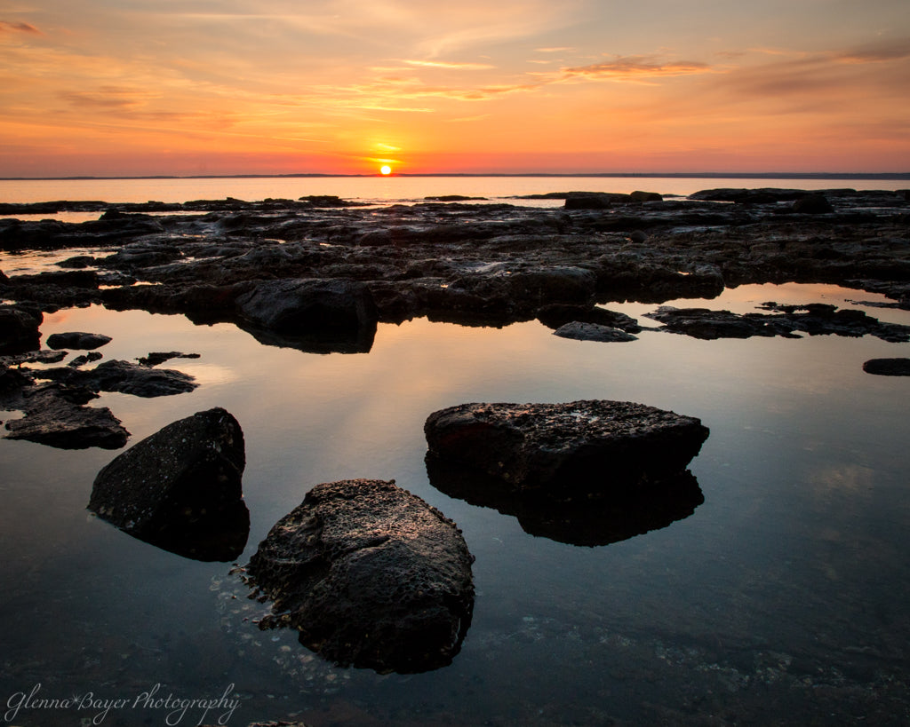 Sunset over the Jervis Bay with rocks and reflection in Australia