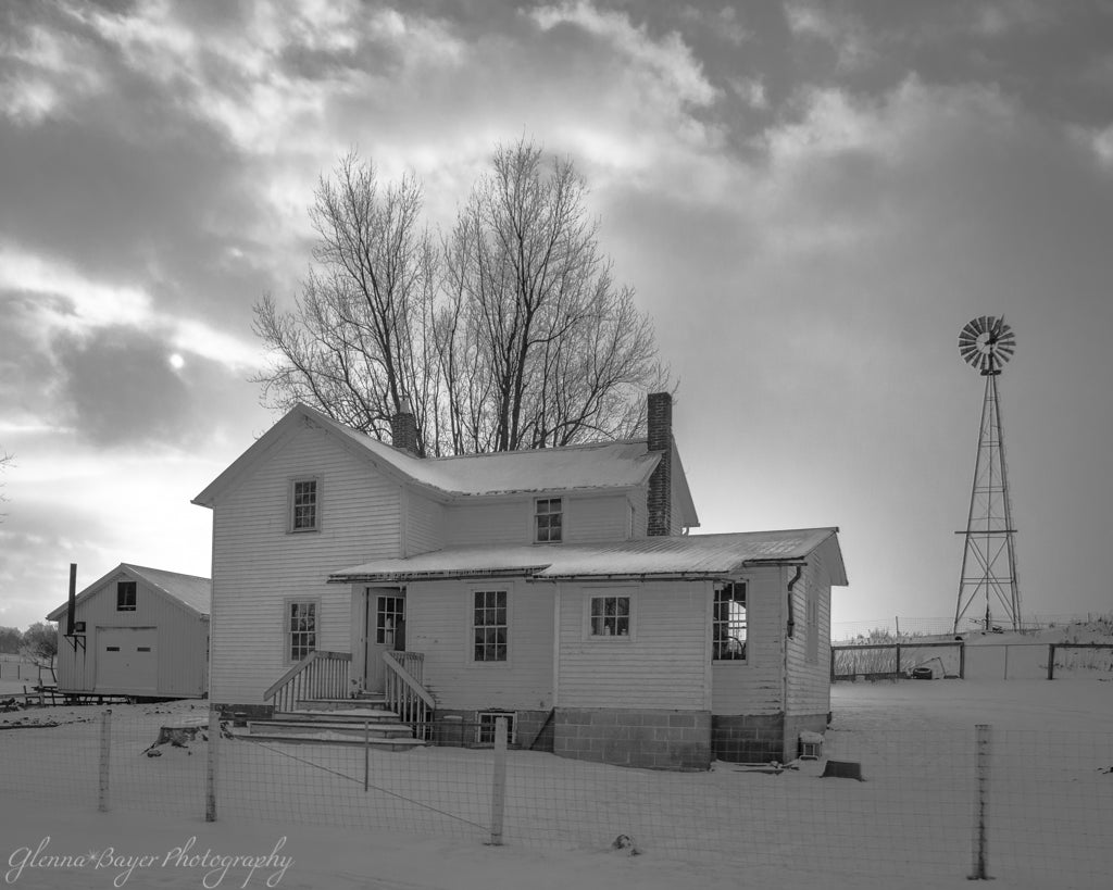 Amish homestead in the snow with a windmill