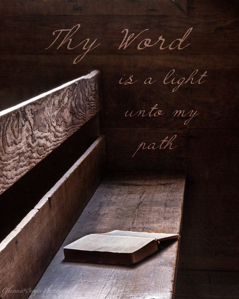 Old Bible lying on wooden bench with scripture verse.