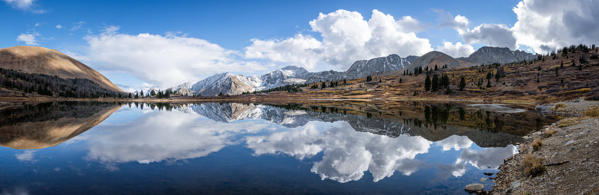blue sky and mountains with reflective lake