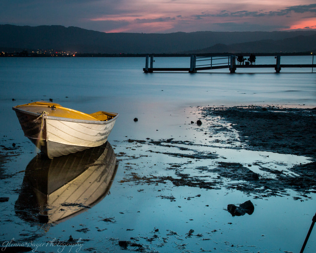 Boat and reflection on Lake Illawara in Australia at sunset
