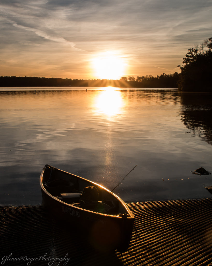 Sunset over lake and canoe at Cowman Lake in Ohio