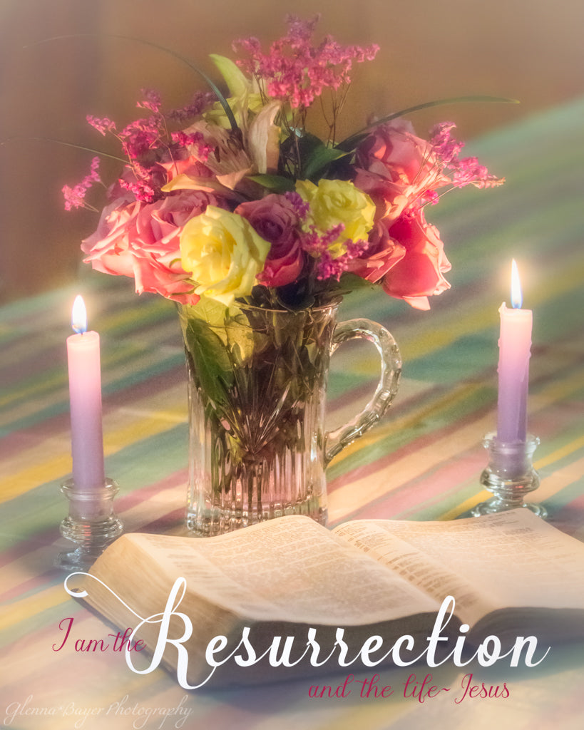 Open Bible with purple candles and pink and yellow spring flower bouquet