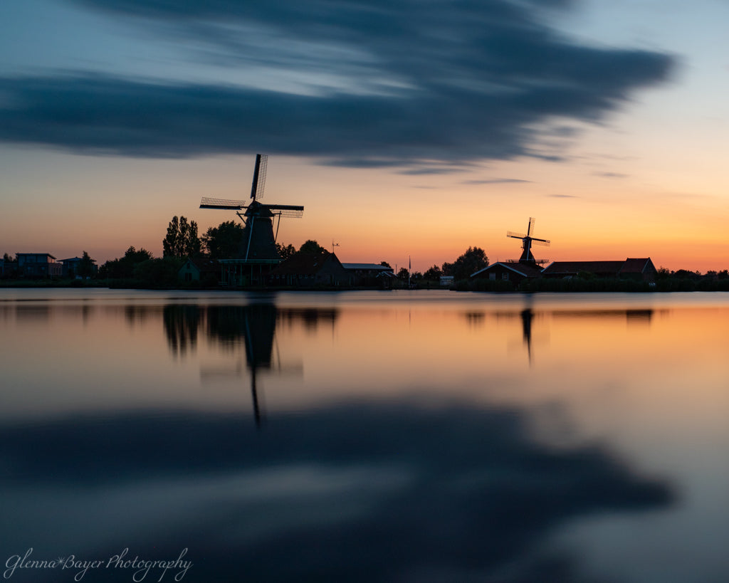Orange sunrise and silhouettes of Holland windmills in Zaanse Schans