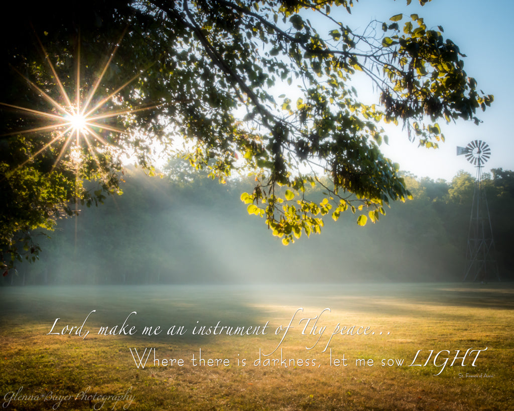 Starburst through trees and sunbeam on field in early morning with scripture verse