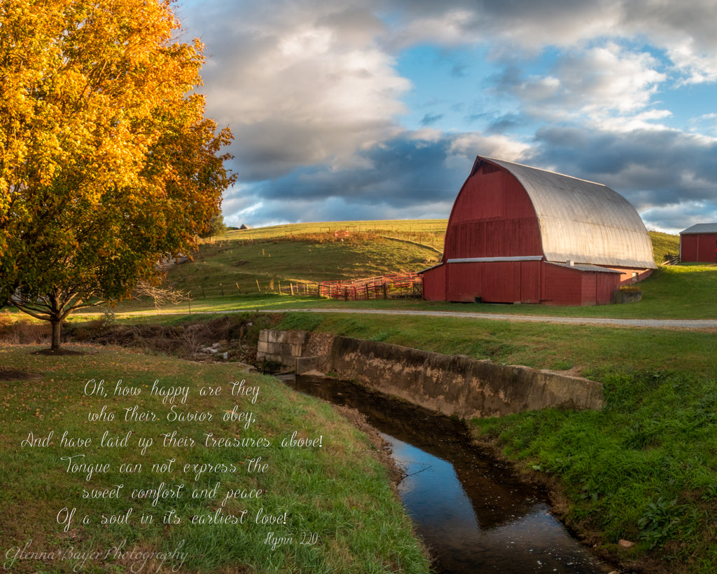 Red barn beside stream in Autumn with song verse