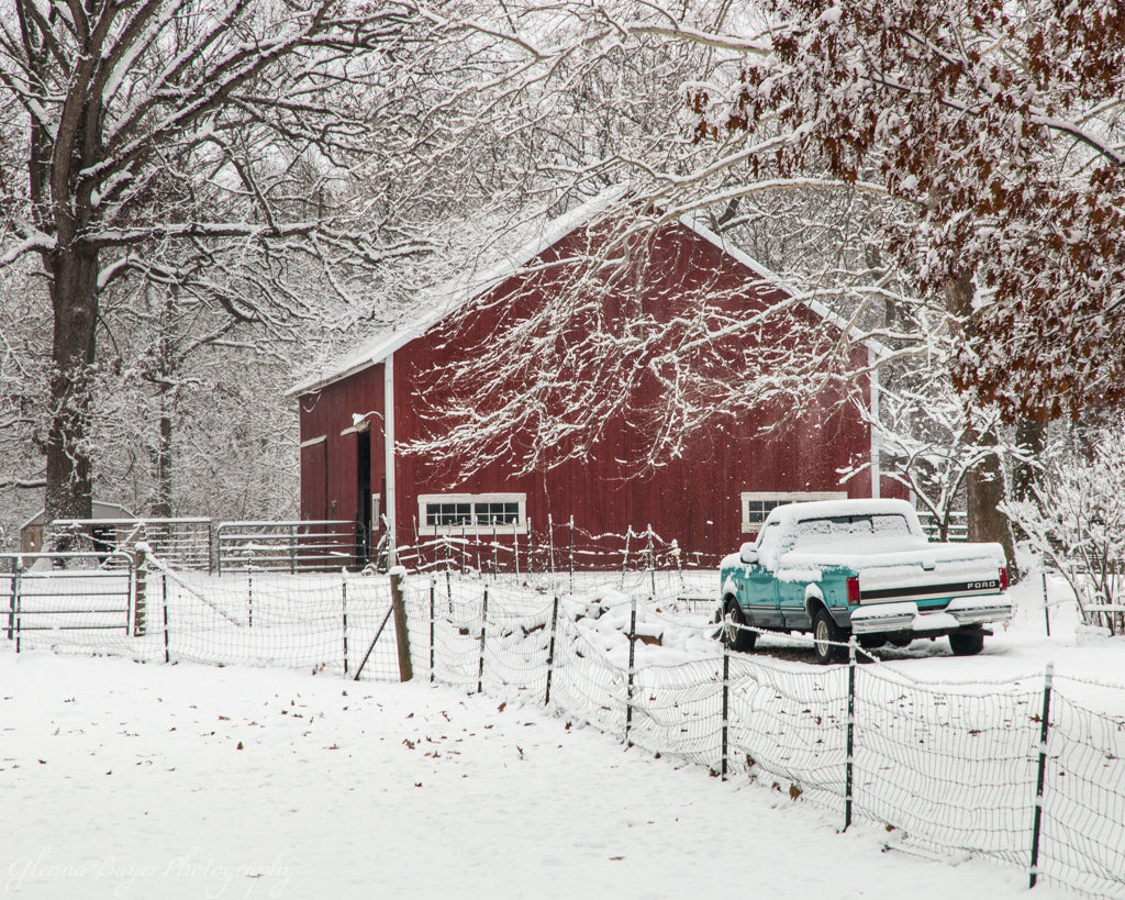 Red barn and old teal ford in snow