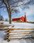 Red barn and wooden fence in snow