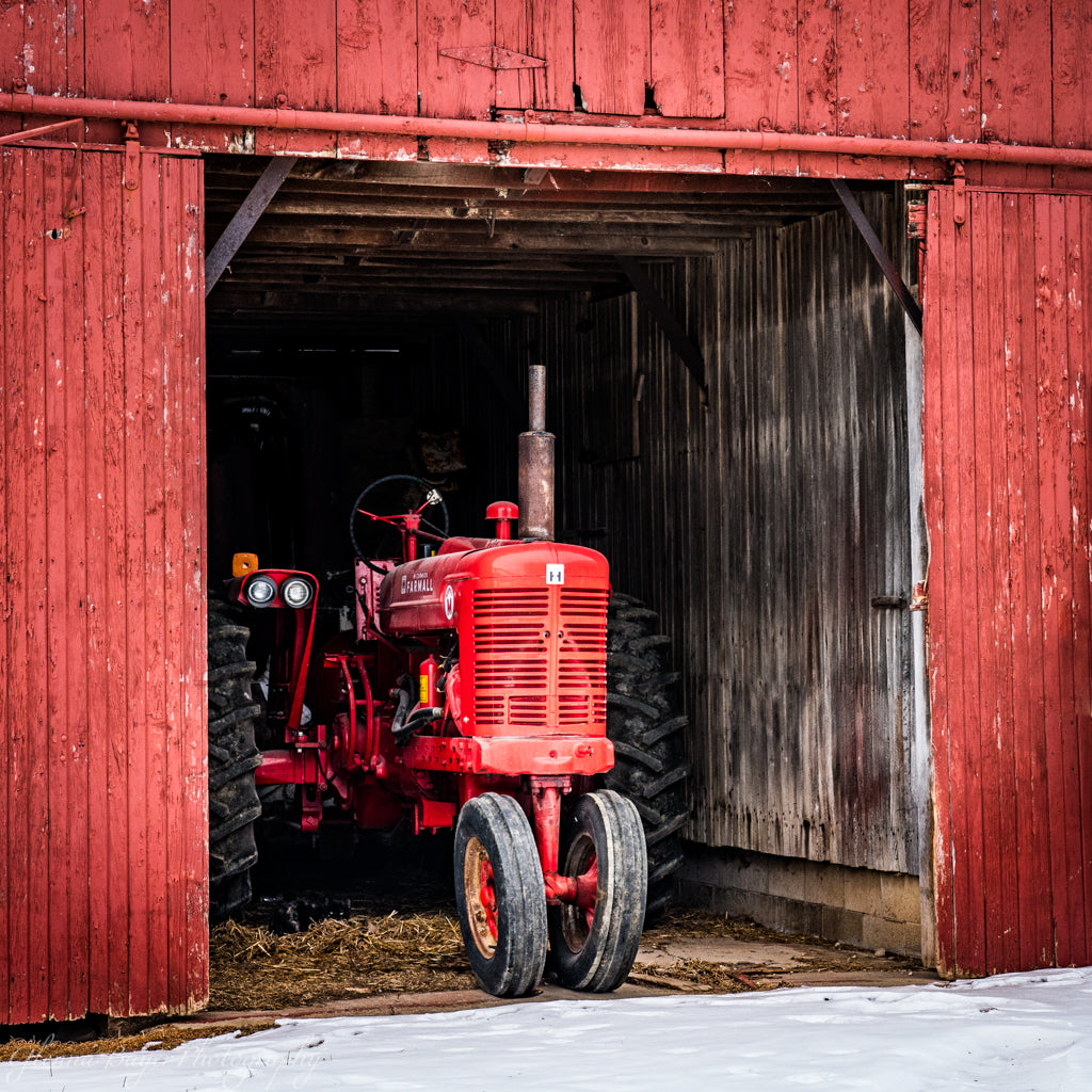 Red Tractor in Red Barn with snow