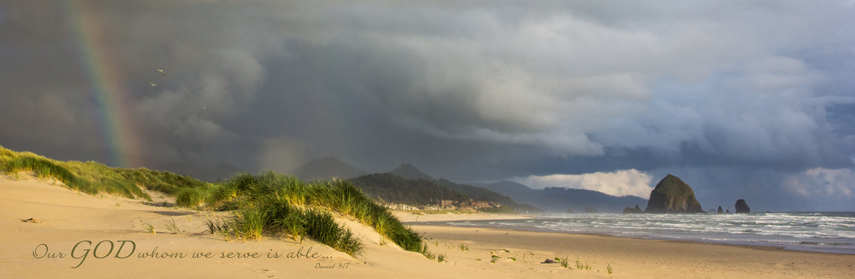 Storm and rainbow over beach at Haystack Rock, Oregon with scripture verse