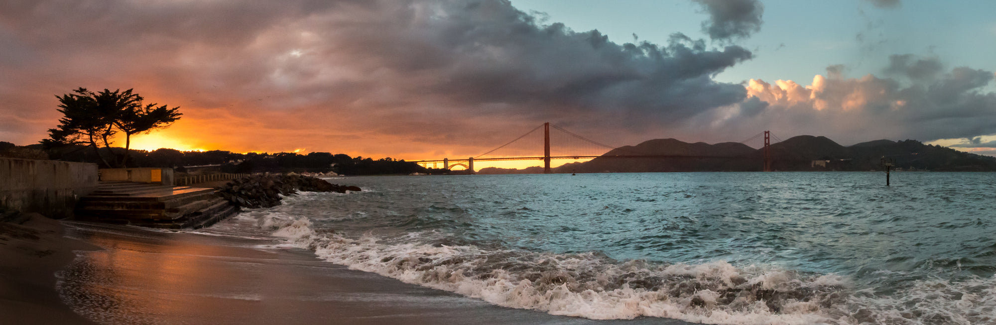 Panorama of orange and blue sunset at the Golden Gate Bridge in California